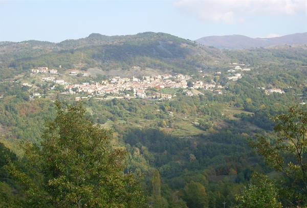 Whitewashed village among green hills, soft morning light