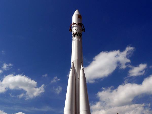 White Vostok rocket monument at VDNKh Moscow, blue sky with clouds