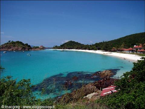 white sand beach with turquoise water, red-roofed buildings, Redang
