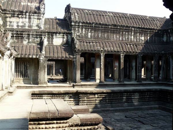 Carved stone galleries and courtyard inside Angkor Wat temple, morning light