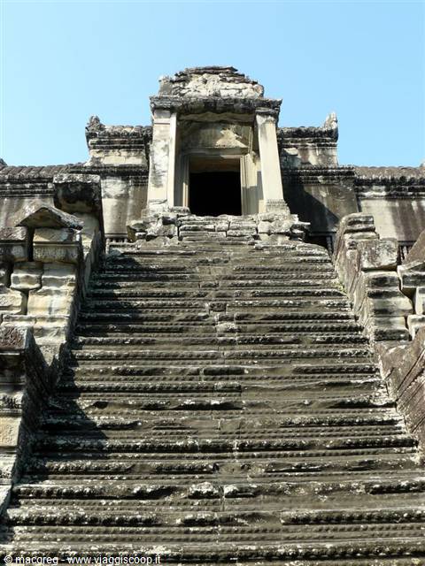 Angkor Wat, steep weathered stone staircase leading to the temple, morning light