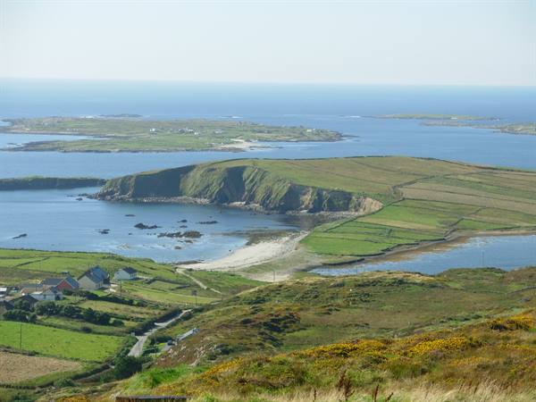 Green fields on headlands, houses and small islands in the ocean near Clifden