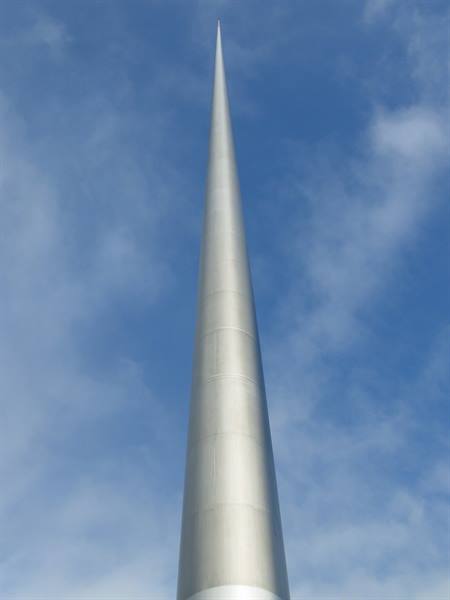 The Spire in Dublin, a steel needle shining against a cloudy sky