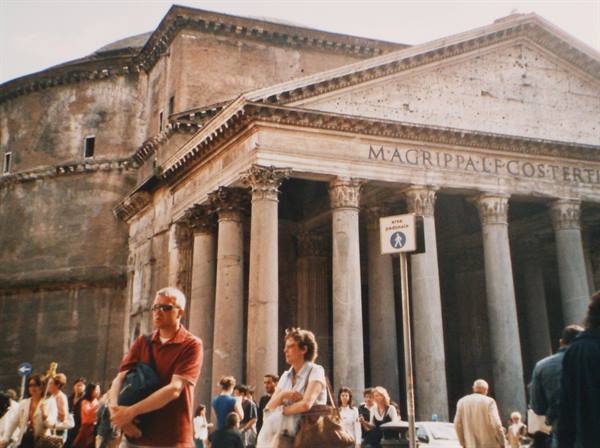 Tourists in front of the Pantheon columns in Rome, bright daylight