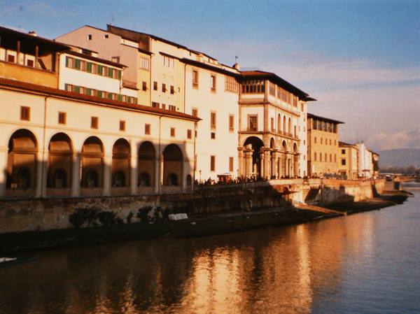 The Uffizi along the Arno in Florence, golden light on Renaissance buildings