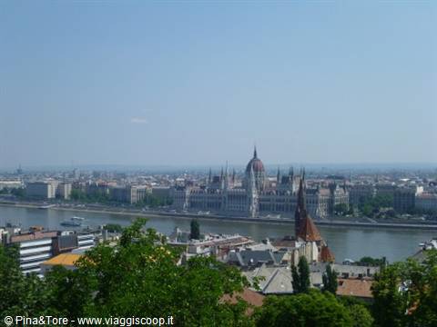 The Hungarian Parliament by the Danube seen over Budapest rooftops