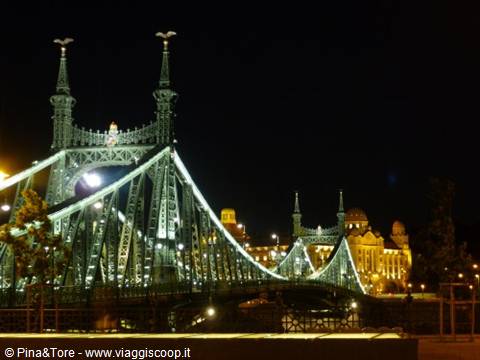 Liberty Bridge illuminated at night in Budapest, green iron structure