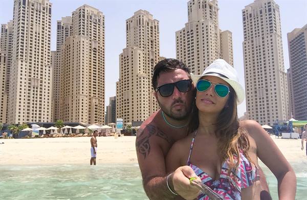 Couple on the beach in front of Dubai Marina skyscrapers