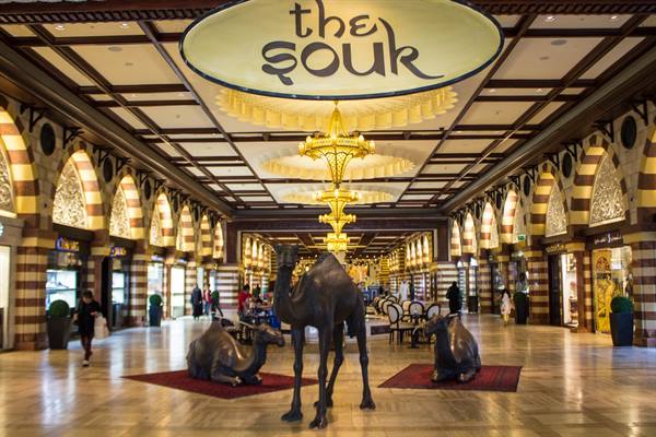 Bronze camel statues under the Souk sign inside the shopping mall