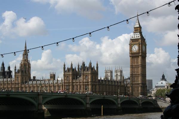 Big Ben and Parliament over Westminster Bridge, string lights, clouds