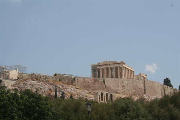 The Parthenon atop the Athens Acropolis, golden marble under a blue sky