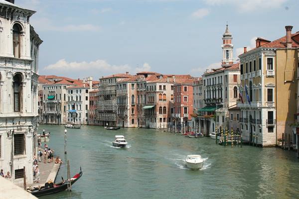 Boats on the Grand Canal among historic palaces and a bell tower, Venice