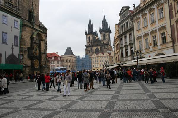 Tourists on the cobbled square in front of Týn Church and the astronomical clock