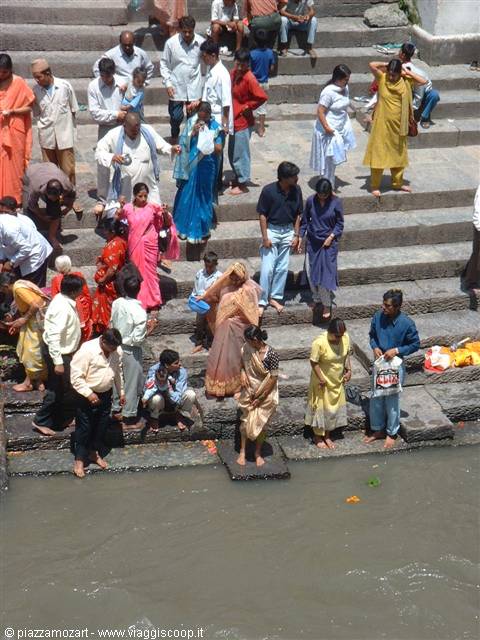 Pilgrims on stone river steps at Pashupatinath temple ghats, Kathmandu