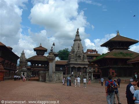 Tourists on the square among stone and brick temples, Bhaktapur
