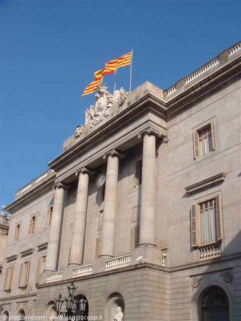 Neoclassical facade of Barcelona City Hall with senyera flags waving