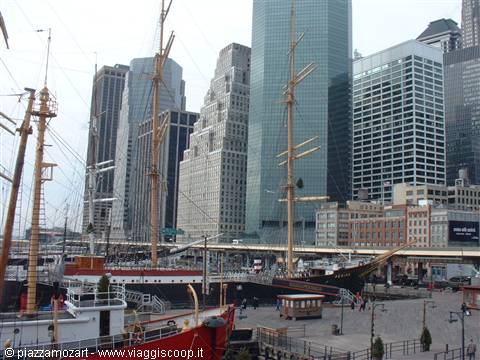 Historic tall ship moored at South Street Seaport pier among Manhattan skyscrapers