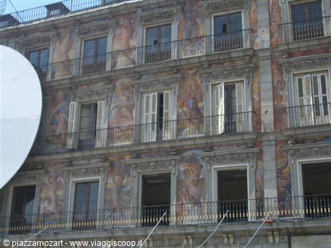Mural-painted facade with iron balconies and windows at Plaza Mayor, Madrid