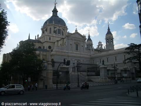 Almudena Cathedral in Madrid, stone dome and towers under cloudy sky