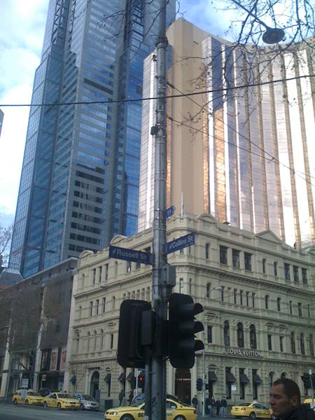 Russell St and Collins St signs, glass towers and taxis, Melbourne