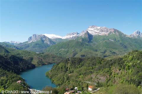 Vagli lake with scattered houses and snowy Apuan Alps