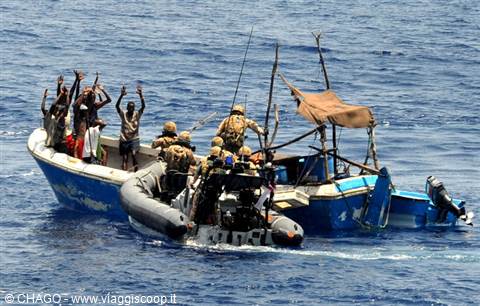 Soldiers in tactical gear on inflatable boat approach fishermen on blue skiff