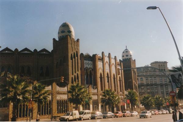 Barcelona's Monumental bullring, brick facade with tiled domes and palm trees