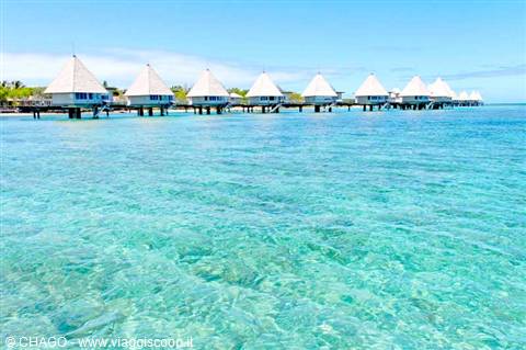 Overwater bungalows on crystal-clear turquoise water, Bora Bora
