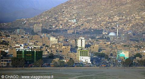 Kabul: brick houses at the foot of the arid mountain, white-domed mosque