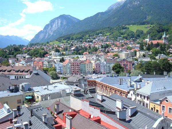 Innsbruck rooftops and colorful houses beneath sunny mountains
