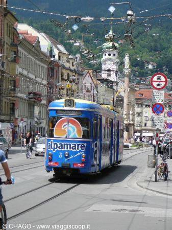 Blue advert tram on Maria-Theresien-Straße in Innsbruck, Annasäule column behind