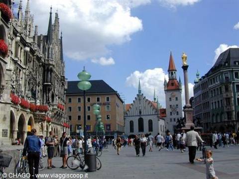 Cyclists and tourists in Marienplatz, Munich, with the gothic town hall