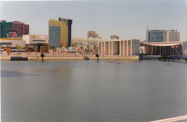 Rowers on the calm basin at Lisbon's Parque das Nações among modern buildings