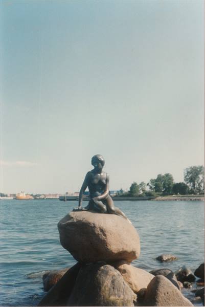 The bronze Little Mermaid statue on a rock by Copenhagen harbor