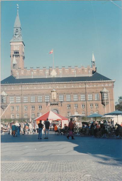 Copenhagen City Hall, red brick with tower, tent and people on the square