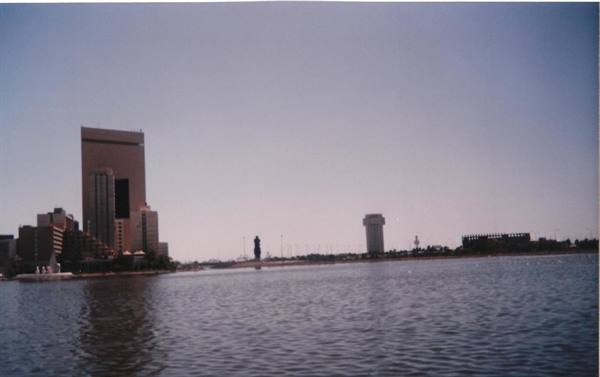 Skyscraper and tower across the bay water, clear sky, daylight