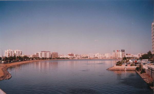 Urban bay with calm waters and buildings along the coast