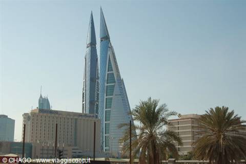 Bahrain World Trade Center twin towers with wind turbines, palms in Manama