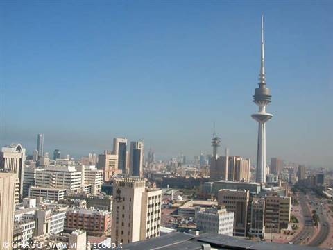 Skyscrapers and Kuwait Liberation Tower under a clear blue sky