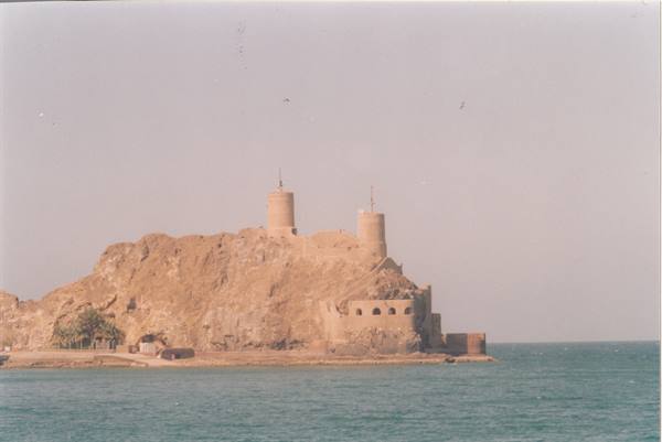 Old stone fort on a rocky islet overlooking the blue sea