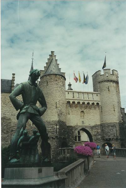 Bronze statue in front of the medieval Het Steen gate, Antwerp