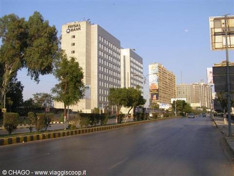 Faysal Bank skyscraper along a tree-lined boulevard in Karachi, morning light