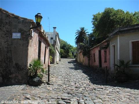 Cobblestone street with colorful colonial houses and lantern, Colonia del Sacramento