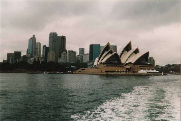 Sydney Opera House white sails seen from the ferry, cloudy sky