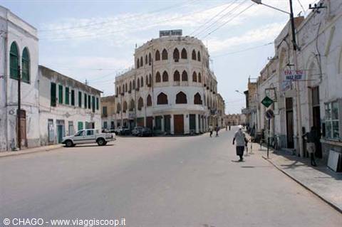 Massawa, white historic arched building at a deserted street crossing