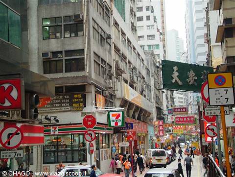 Busy street with Chinese signs, tall buildings and a 7-Eleven store, Hong Kong