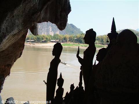 Pak Ou caves: Buddha statues silhouetted against the Mekong river