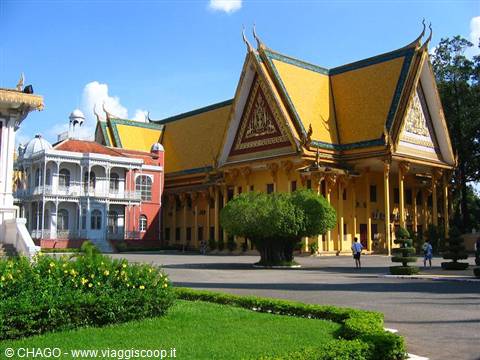 Golden pavilion of Phnom Penh Royal Palace, yellow roof, tourists walking