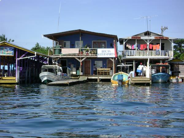 Wooden stilt houses in Bocas del Toro, watersports boats and laundry over the water