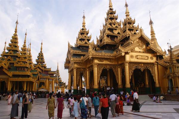 Pilgrims walking among the golden spires of Shwedagon Pagoda, Yangon